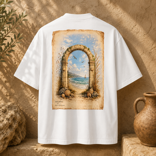 SOLARA II Tide Line organic cotton oversized tee in white — back view with coastal stone archway artwork