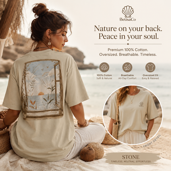 Woman wearing SOLARA I First Light organic cotton oversized tee in stone beige on a beach at sunrise